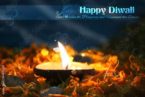 Diwali diya on flower rangoli photo