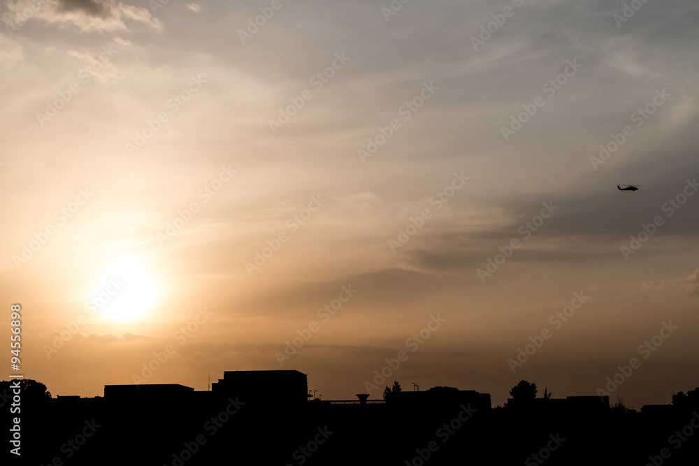 Jerusalem skyline silhouette at sunset with a chopper 
