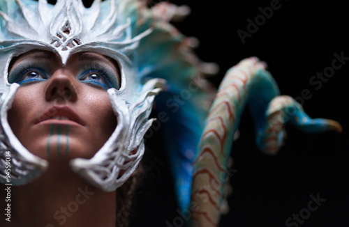 Fantasy concept of a young girl,strong brave warrior,wearing a helmet - mask with horns on head with corals with dots