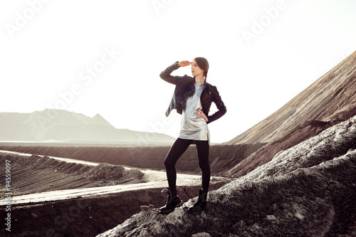 Beautiful fashion young woman climbing into mountains