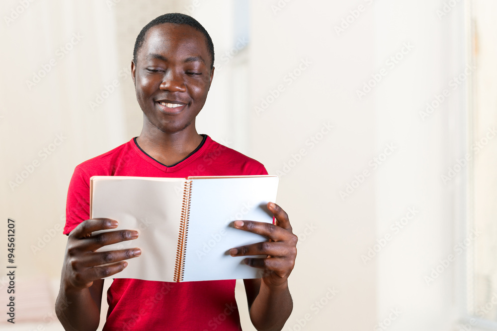 Young African American Male Holding Notepad Young African American Male Holding Notepad