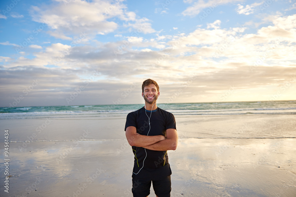 Man smiling on the beach in the morning before his run Man smiling on the beach in the morning before his run