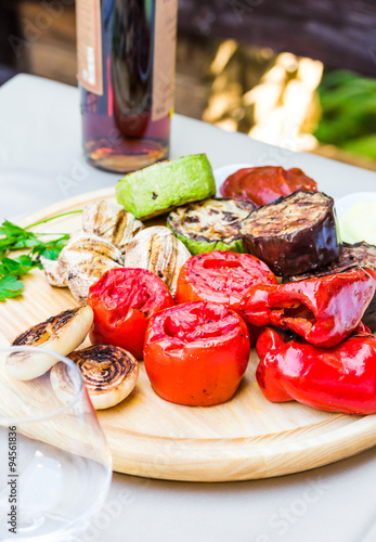 grilled vegetables and mushroom with sauce on a wooden board