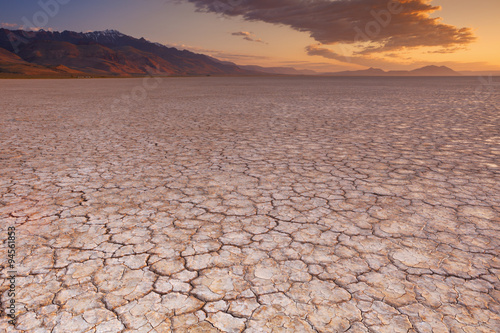 Cracked earth in remote Alvord Desert, Oregon, USA at sunrise