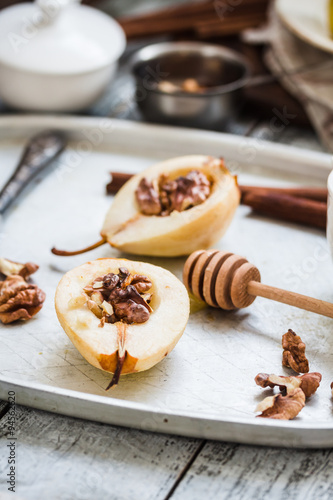 spicy baked pear with walnuts  honey  cinnamon sticks  healthy d