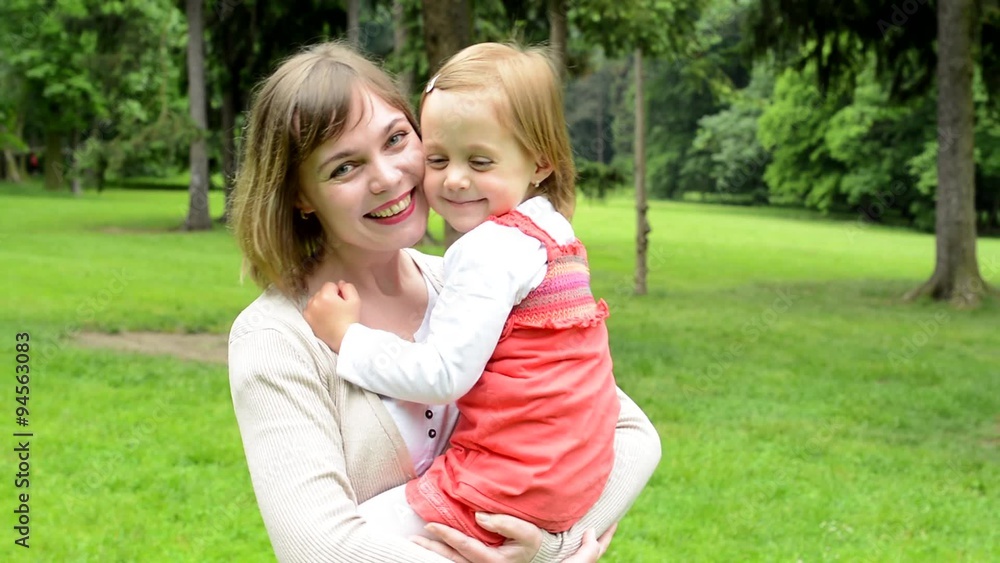 pretty mother with cute daughter smile to camera - park pretty mother with cute daughter smile to camera - park