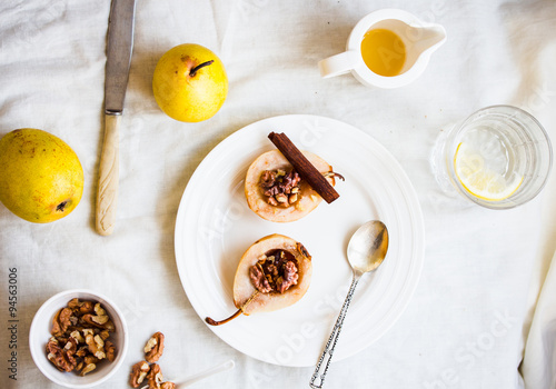 spicy baked pear with walnuts, honey, healthy dessert,top view