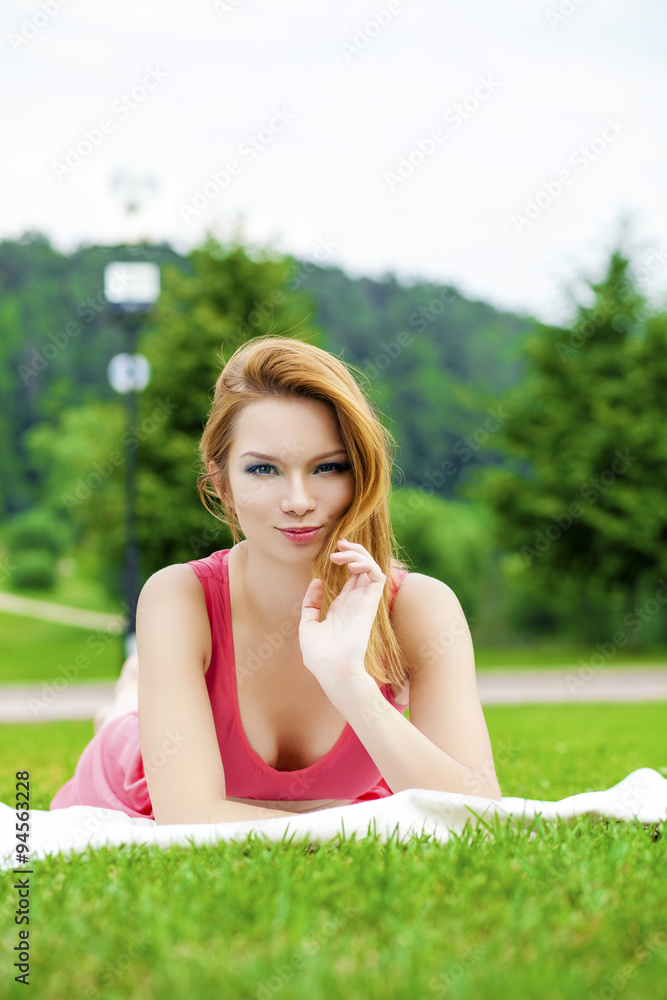 Romantic young woman outdoors at a summer day