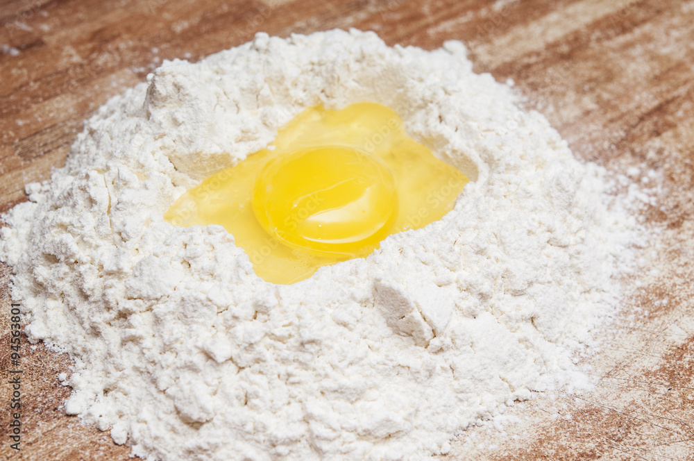 Broken egg on flour, means for making bread Broken egg on flour, means for making bread