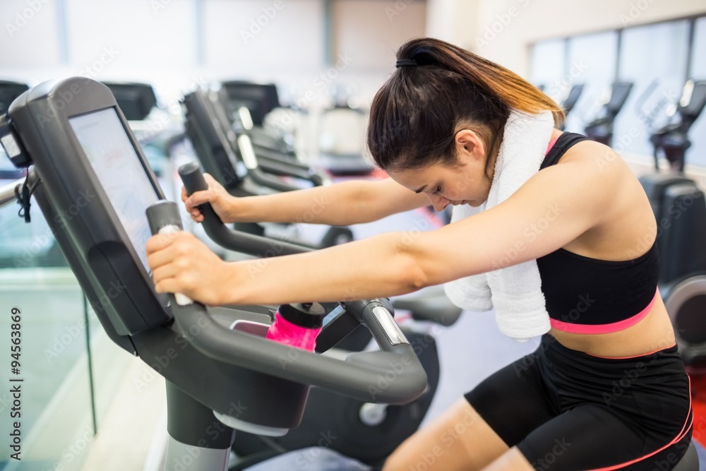 Exhausted woman on the exercise bike Exhausted woman on the exercise bike