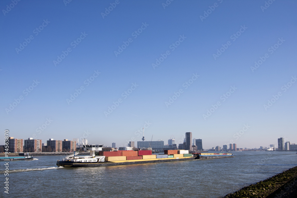 Container ship pushing a container barge on the river Meuse in Rotterdam