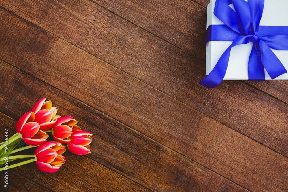 Fototapeta premium View of red flowers and blue gifts