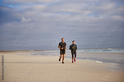 Two people enjoying a beach run together