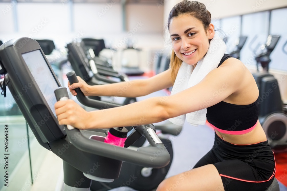 Smiling woman on the exercise bike Smiling woman on the exercise bike