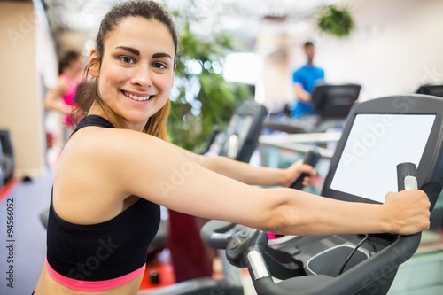 Smiling woman on the exercise bike