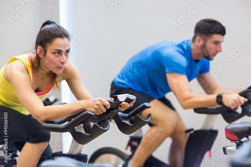 Couple using exercise bikes together
