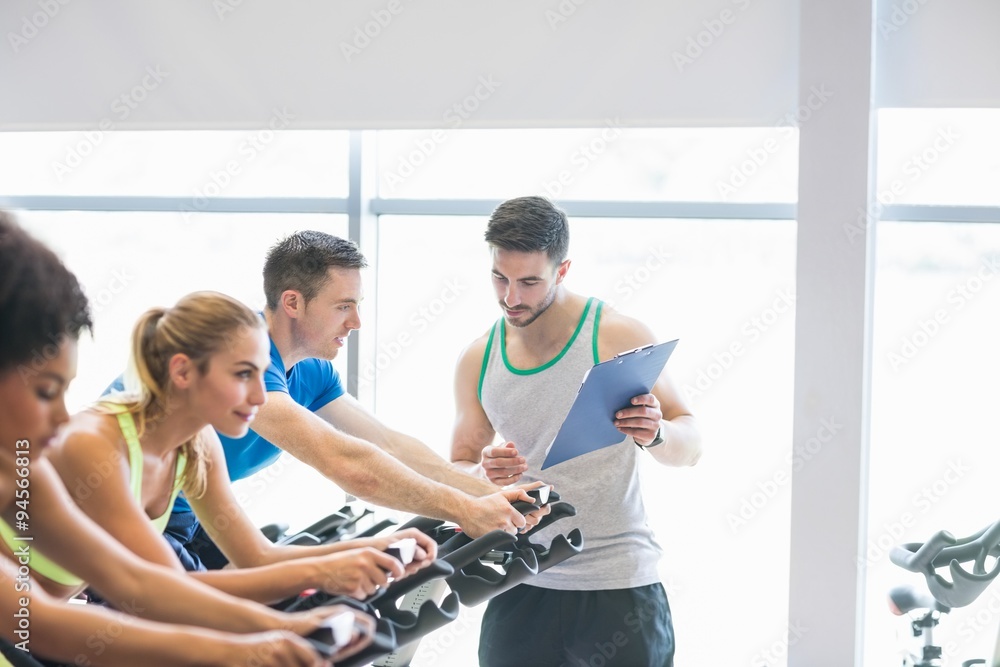 Fit people in a spin class Fit people in a spin class