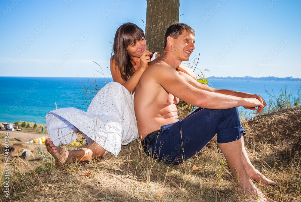 young couple against the sea