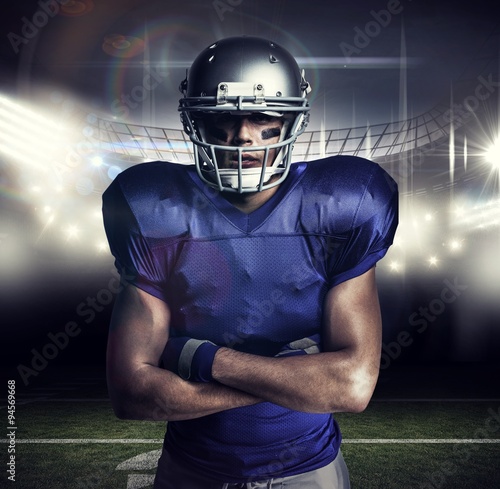 Composite image of american football player with arms crossed