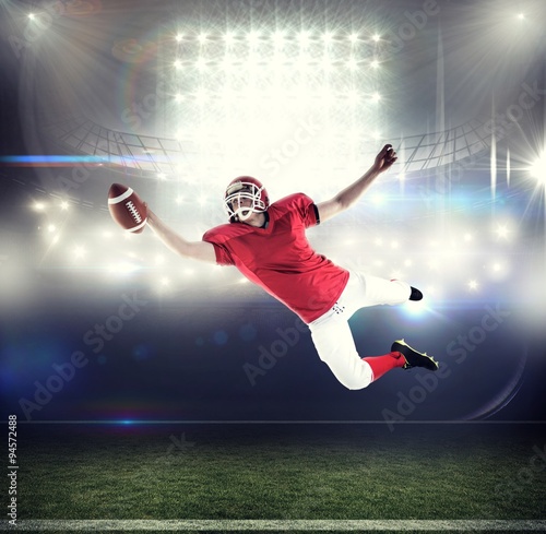 Composite image of american football player scoring a touchdown © vectorfusionart