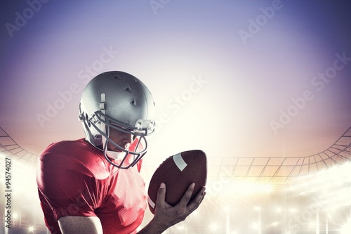 Sportsman looking at american football ball