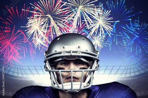 Portrait of american football player against firework