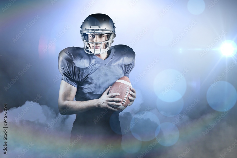 Composite image of american football player holding ball Composite image of american football player holding ball