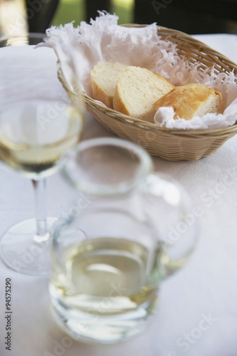Bread and wine served before a meal on a restaurant table