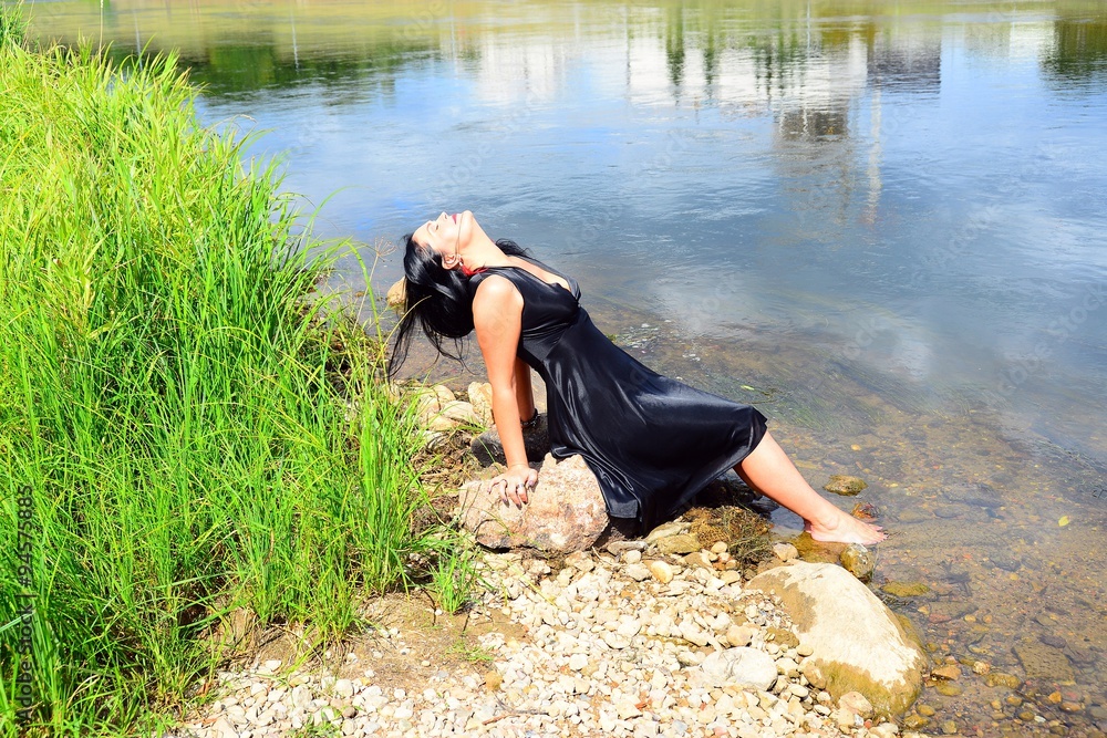 A woman in black on riverside of Neris river in Vilnius