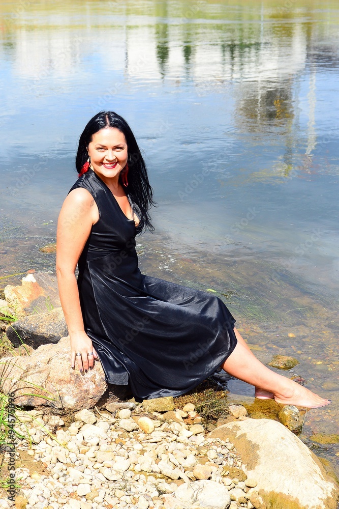 A woman in black on riverside of Neris river in Vilnius