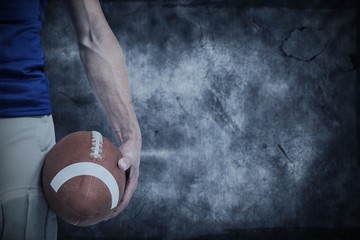 Composite image of midsection of sports player holding ball