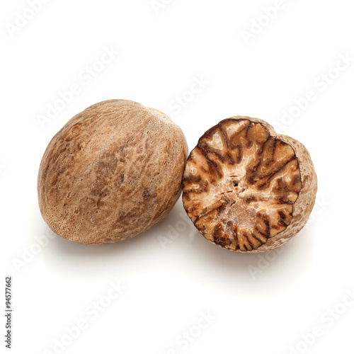 Macro closeup of a full and a cracked Organic Nutmeg Seed or Jaiphal (Myristica fragrans) isolated on white background.