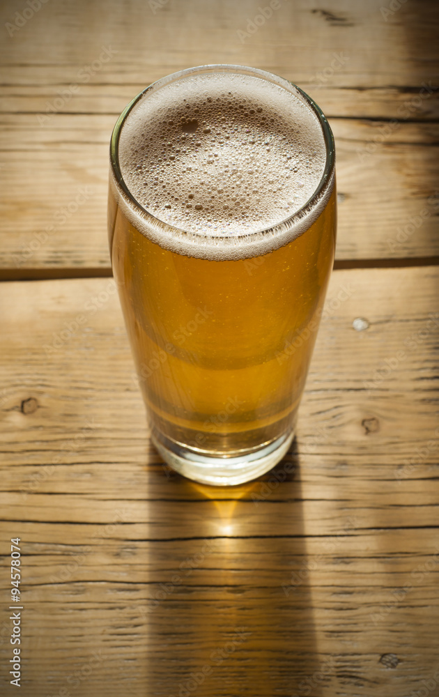 Beer barrel with glass on table wooden background Beer barrel with glass on table wooden background