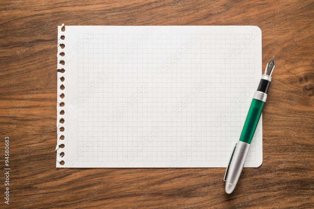 Paper with pen on a wooden desk Paper with pen on a wooden desk