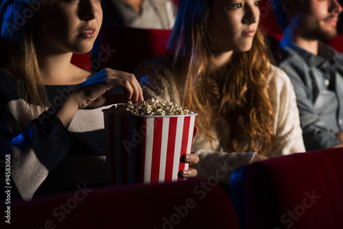 Friends at the cinema watching a movie