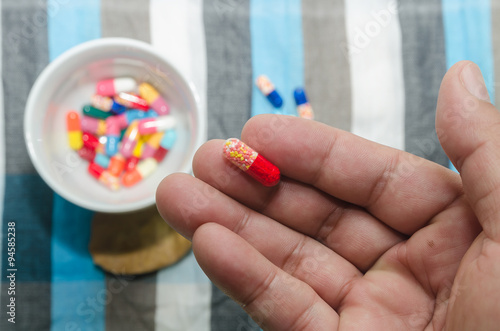 closeup vitamin capsule on hand