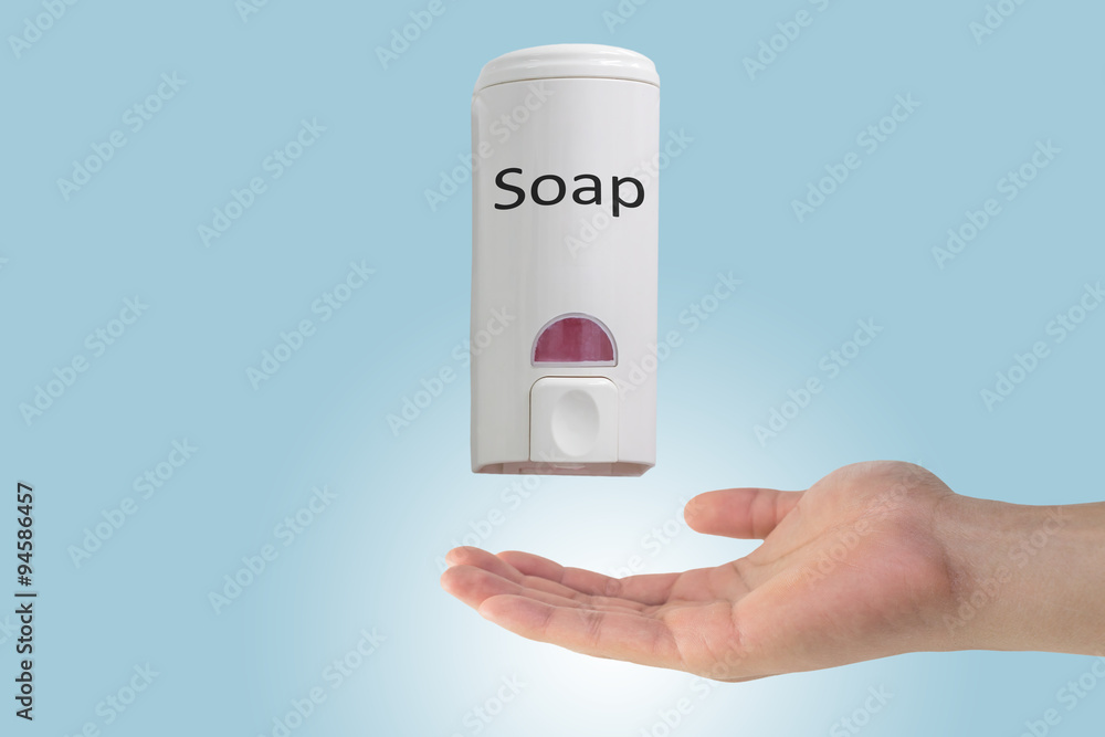 Hand using soap from soap dispenser Hand using soap from soap dispenser