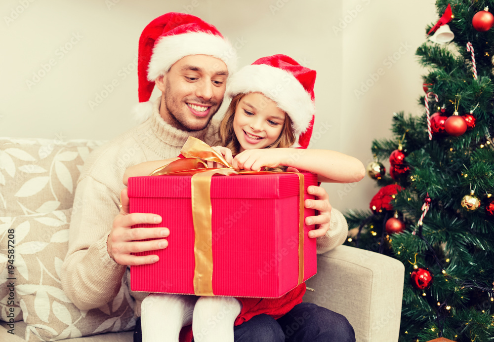 smiling father and daughter opening gift box smiling father and daughter opening gift box