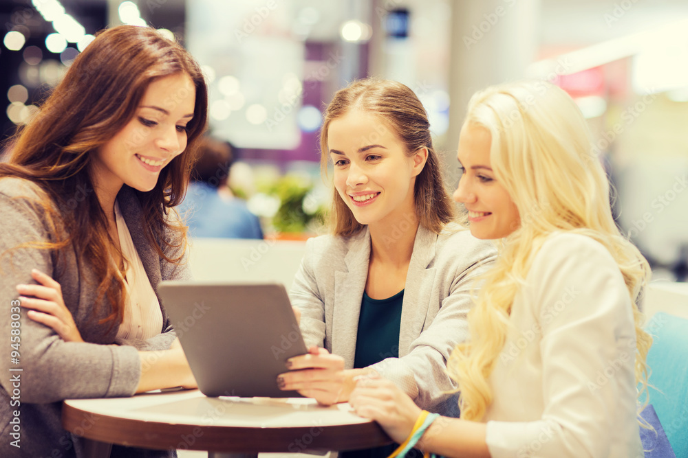 happy young women with tablet pc and shopping bags happy young women with tablet pc and shopping bags