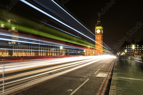 Big Ben at night with the lights of the cars passing