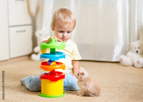 Child boy plays with a kitt...