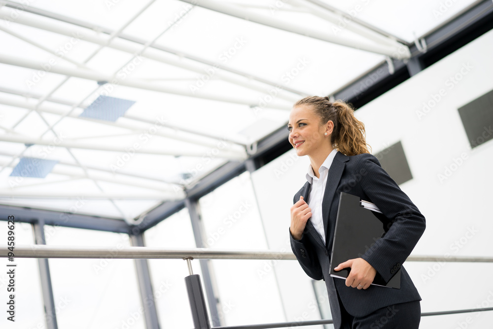 businesswoman talking on a mobile phone at the office businesswoman talking on a mobile phone at the office