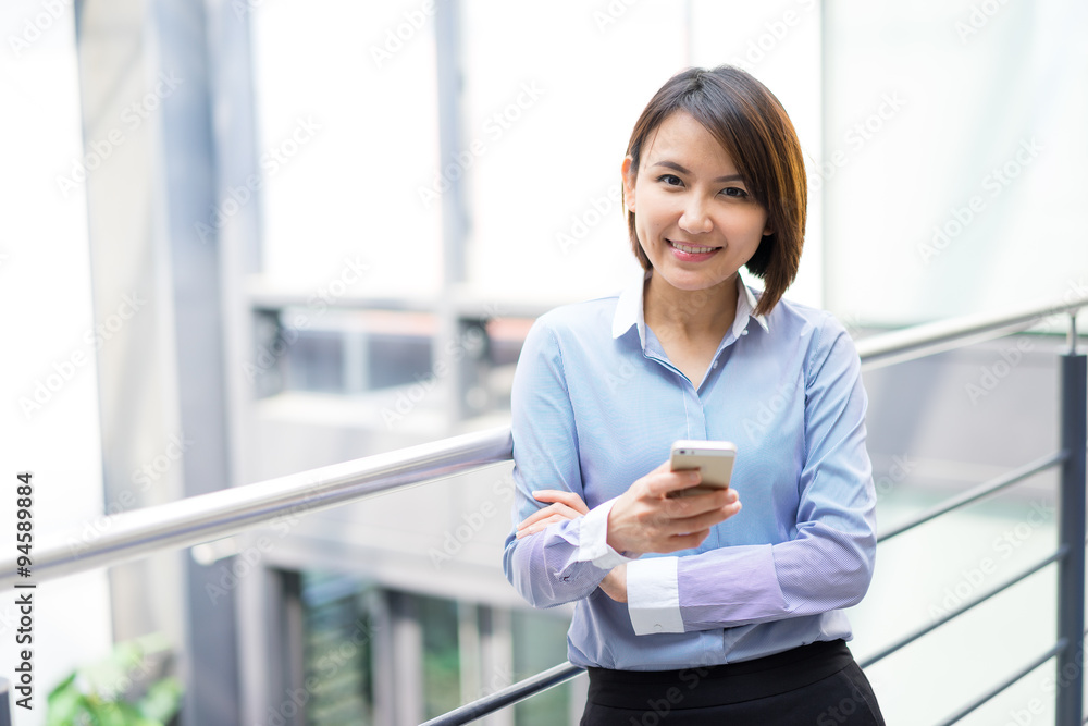 Asian businesswoman talking on a mobile phone at the office Asian businesswoman talking on a mobile phone at the office