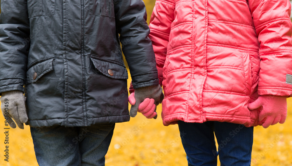 close up of girl and boy holding hands outdoors close up of girl and boy holding hands outdoors