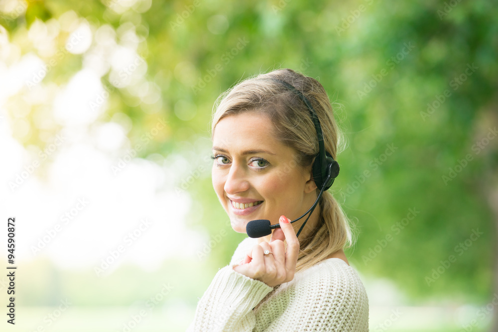 Business woman talking using her headset in the park Business woman talking using her headset in the park