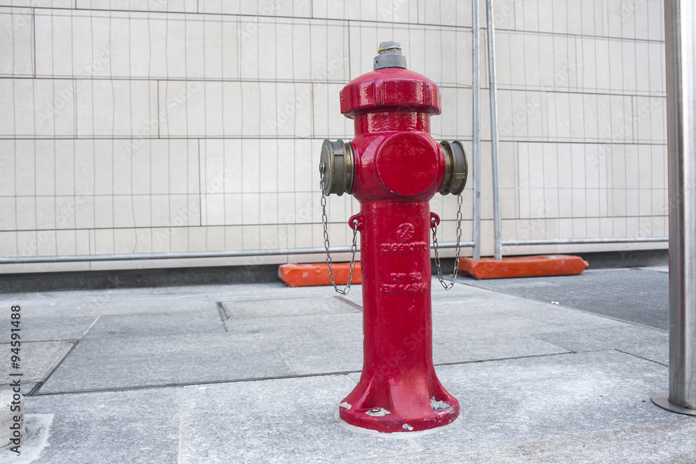 MILAN, ITALY OCTOBRE 20, 2015: New red water pump for fire fighting, fire hydrant in the city MILAN, ITALY OCTOBRE 20, 2015: New red water pump for fire fighting, fire hydrant in the city