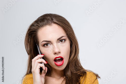 Woman with mouth open talking on the phone