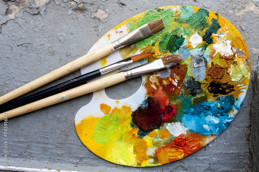 Fototapeta premium Brushes and colorful abstract oil colors paiters pallet, on grunge background