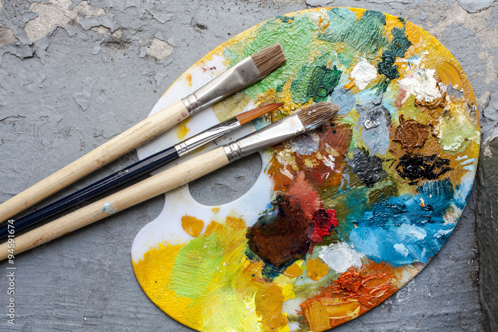 Fototapeta premium Brushes and colorful abstract oil colors paiters pallet, on grunge background