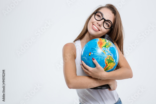Smiling woman in glasses holding globe photo